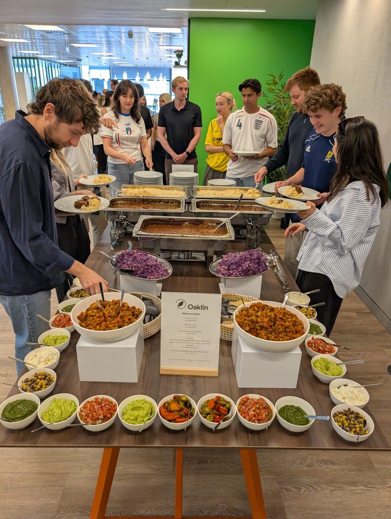 Guests choosing food from a Mexican-style hot buffet at a corporate event