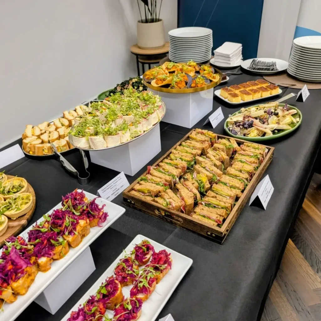 Corporate buffet display with sandwiches, wraps, salads and finger food