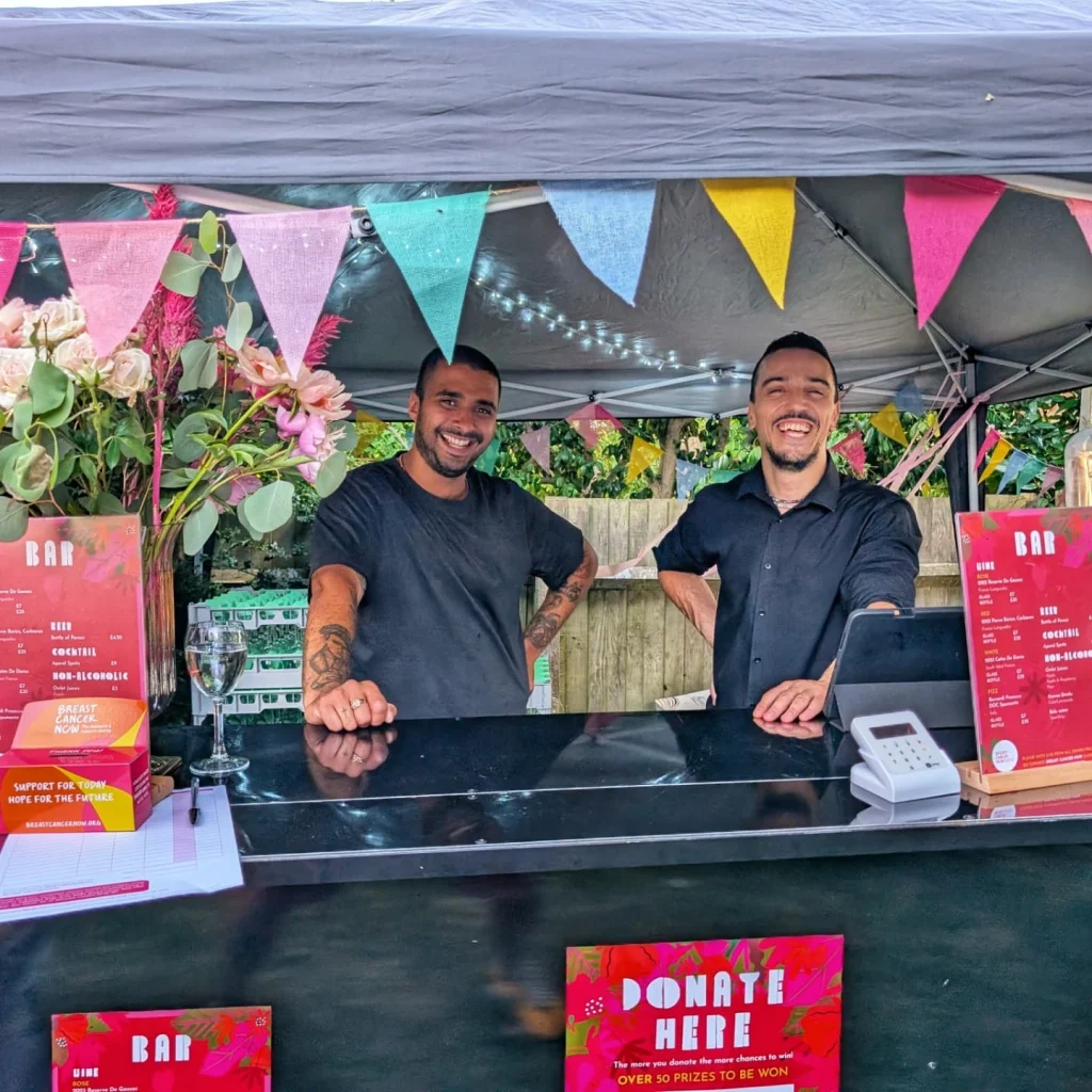 DOM bartenders serving at an outdoor charity event bar