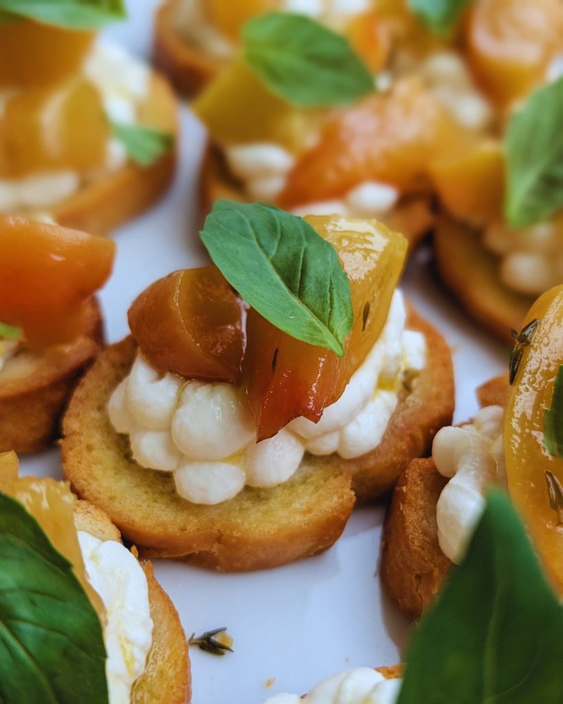Savoury crostini with ricotta, roasted peaches and fresh basil