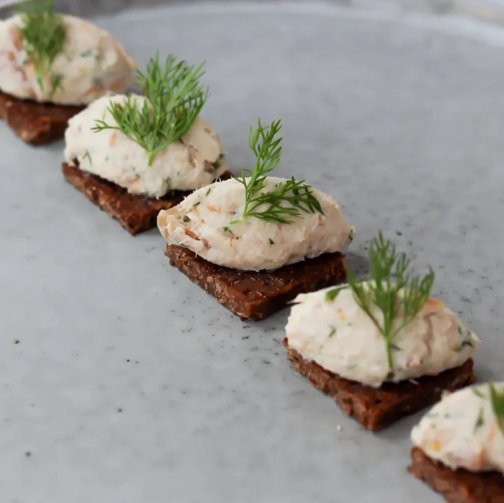 Herb-topped savoury bites arranged for a London finger food event